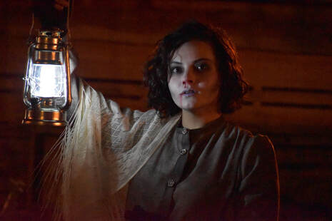 spooky tour guide holding lantern